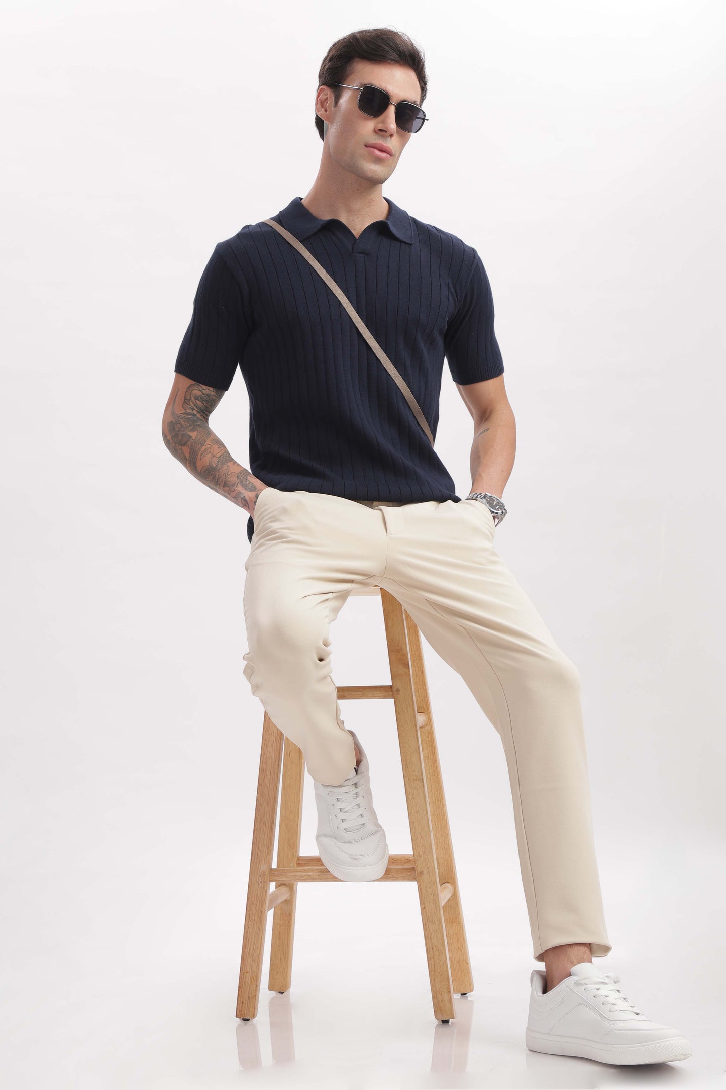 Model wearing marine blue buttonless polo shirt – classic old money style by The Seasons