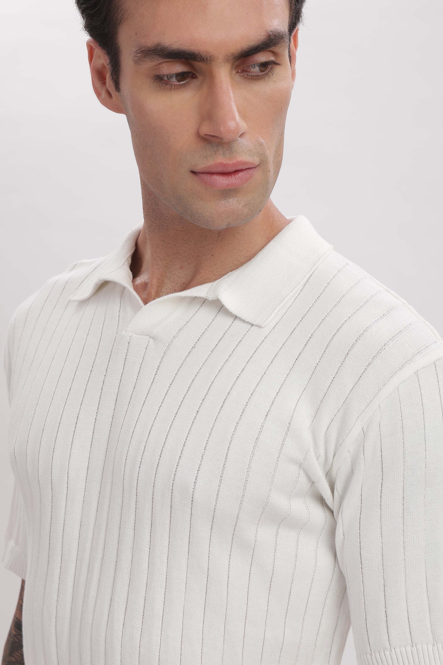 Closeup of ivory polo shirt fabric and stitching – premium craftsmanship by The Seasons