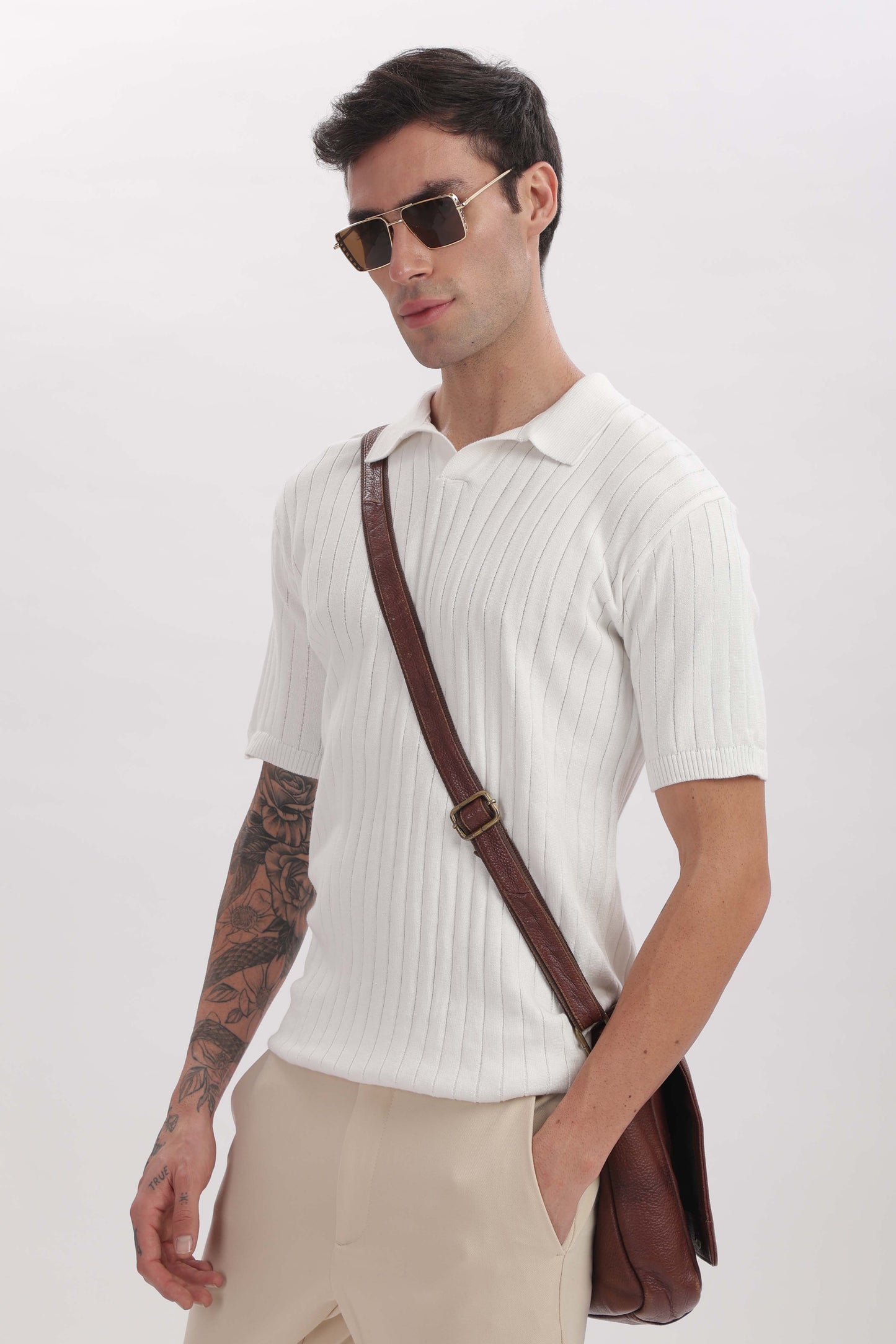 Model wearing ivory buttonless polo shirt – refined old money style by The Seasons