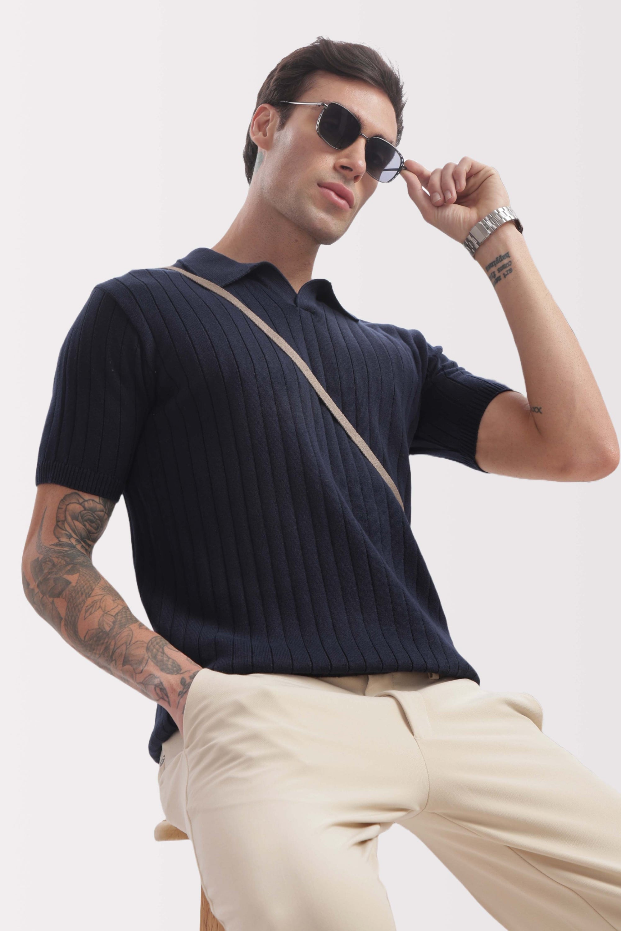 Model wearing marine blue buttonless polo – classic old money style by The Seasons